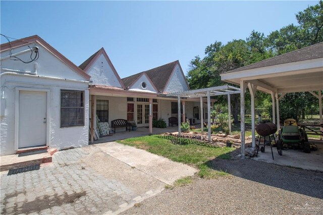 11009 Monte Cristo Rd, Edcouch, TX 78538 - rear view of property with french doors, a pergola, and a patio area