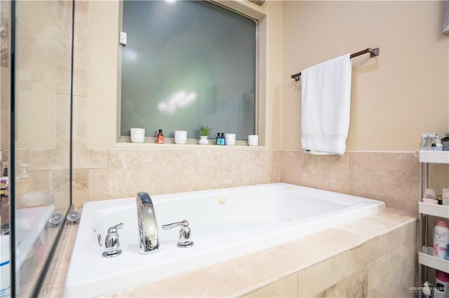 bathroom with a relaxing tiled tub