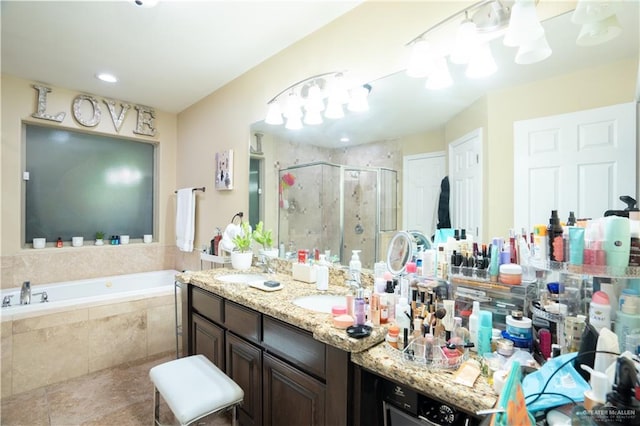 bathroom featuring vanity and independent shower and bath