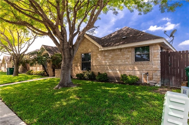 view of side of home featuring a yard