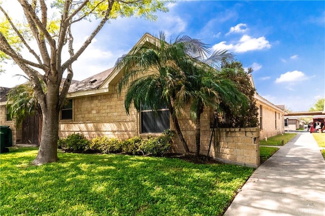 view of side of property featuring a yard