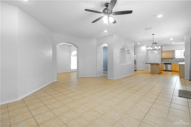 unfurnished living room with sink, light tile patterned flooring, and ceiling fan with notable chandelier