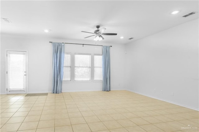 tiled spare room with ceiling fan