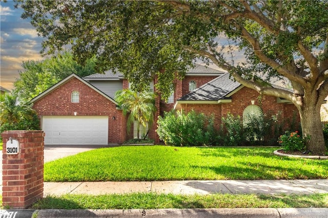 front of property featuring a garage and a yard