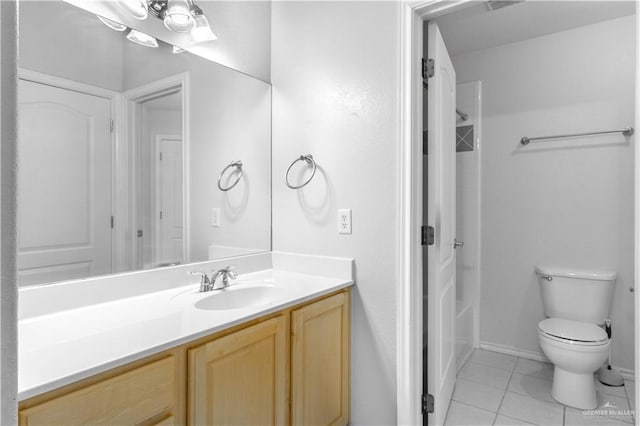 bathroom featuring tile patterned floors, vanity, and toilet