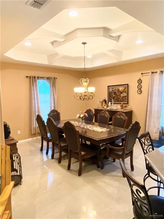 dining area with a tray ceiling and an inviting chandelier