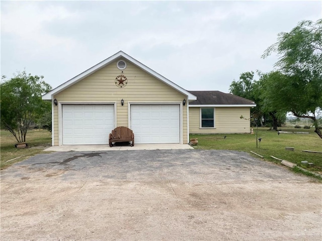 ranch-style home featuring a garage and a front lawn