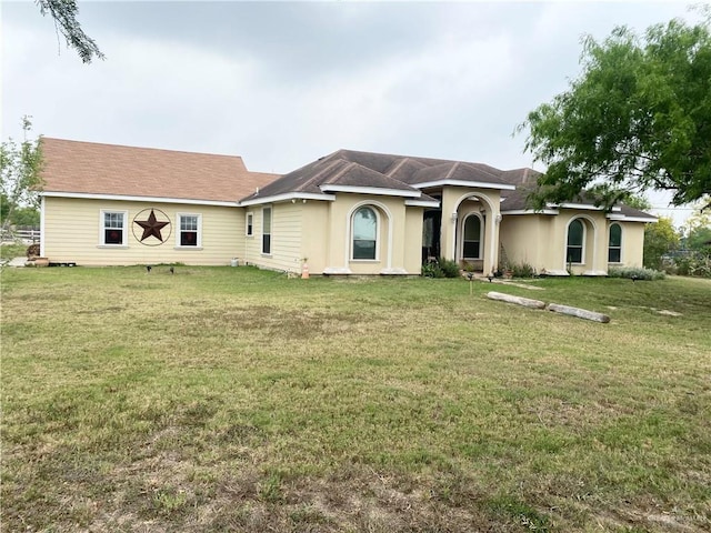 ranch-style home featuring a front yard