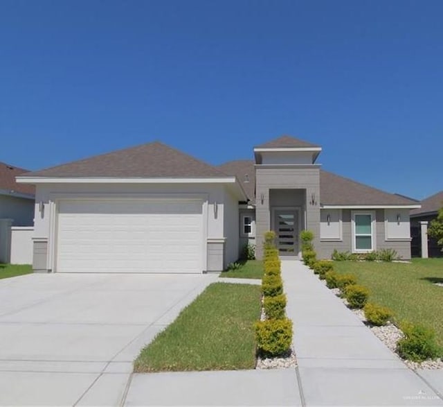 view of front facade with a front yard and a garage