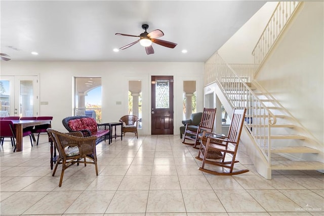 foyer featuring ceiling fan and ornate columns