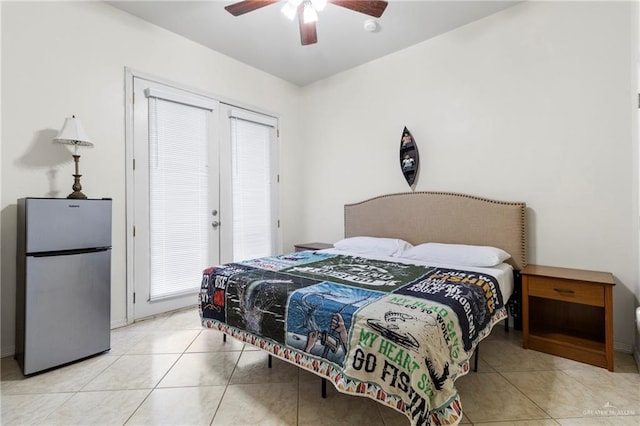 bedroom with ceiling fan, light tile patterned floors, french doors, and stainless steel refrigerator