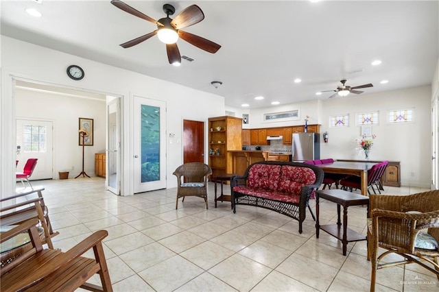 tiled living room with ceiling fan