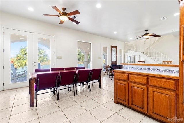 kitchen featuring light tile patterned flooring, ceiling fan, and french doors