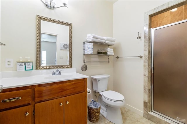 bathroom featuring vanity, a shower with shower door, tile patterned floors, and toilet