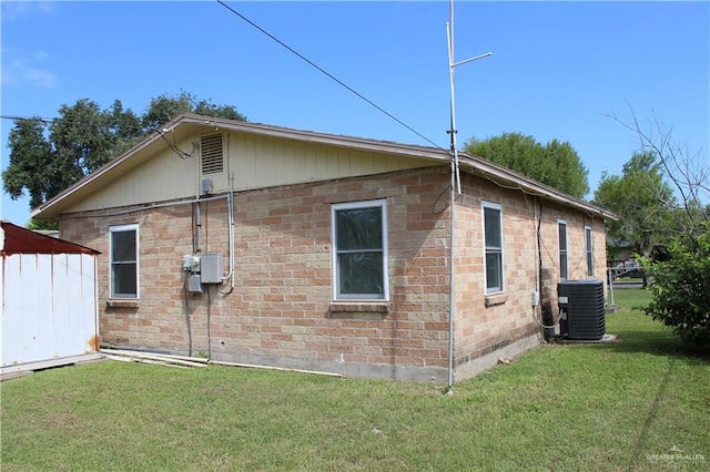 view of home's exterior featuring cooling unit and a lawn