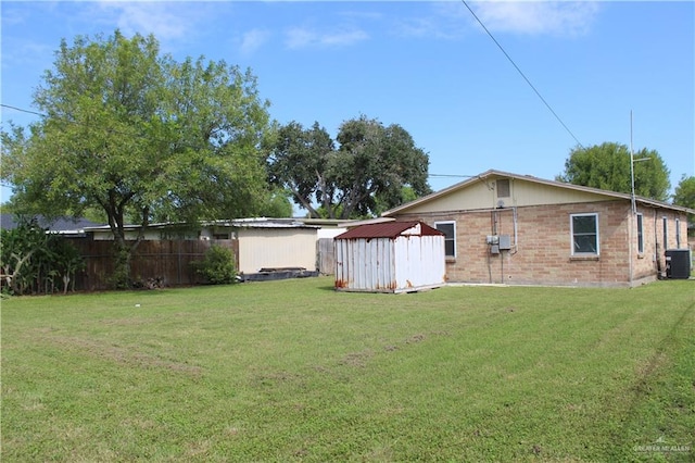 view of yard featuring a storage unit and cooling unit