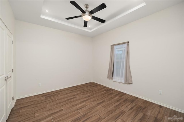 7809 N 27th St, Mcallen, TX 78504 - unfurnished bedroom with wood finished floors, a tray ceiling, recessed lighting, and ceiling fan