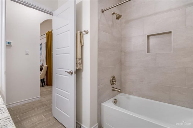 2104 Macquarie Dr, Edinburg, TX 78542 - full bathroom with wood finished floors, tub / shower combination, and baseboards