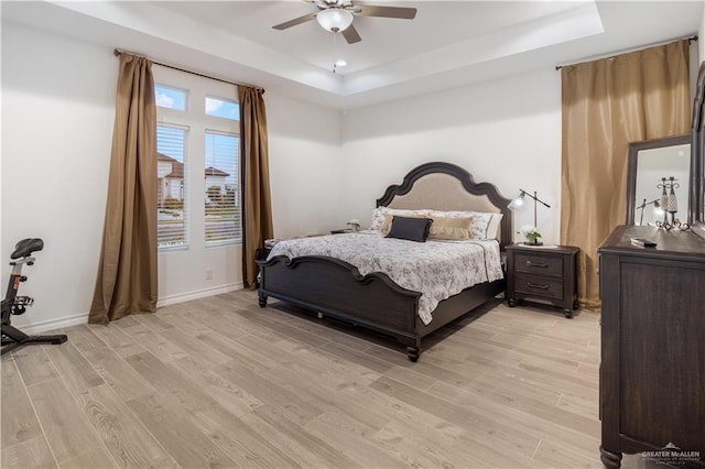 2104 Macquarie Dr, Edinburg, TX 78542 - bedroom featuring a tray ceiling, light wood-style flooring, baseboards, and ceiling fan
