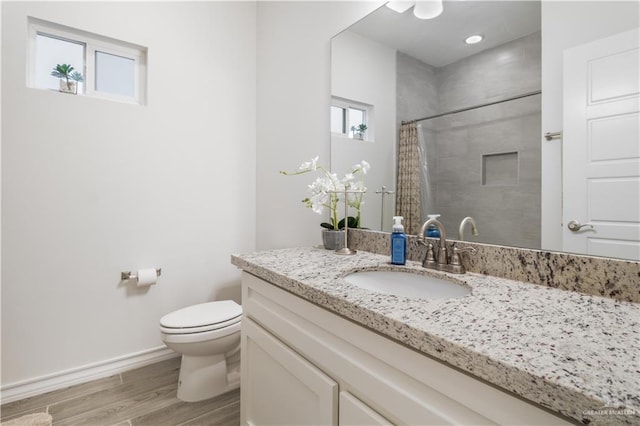 2104 Macquarie Dr, Edinburg, TX 78542 - bathroom with toilet, wood finished floors, baseboards, a shower with curtain, and vanity