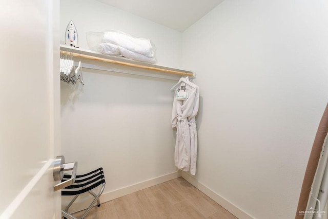 walk in closet featuring light hardwood / wood-style flooring