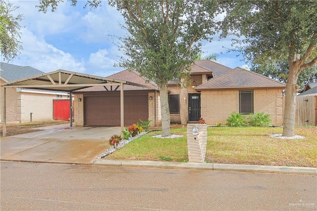 view of front of property featuring a garage, a front yard, and a carport