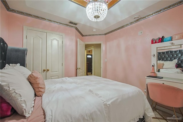 bedroom featuring a closet and an inviting chandelier