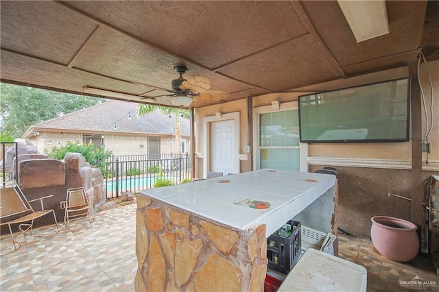 view of patio featuring ceiling fan and a swimming pool