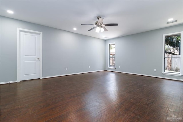 spare room featuring ceiling fan and dark wood-type flooring