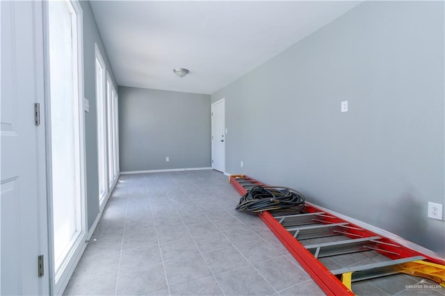 corridor featuring light tile patterned floors