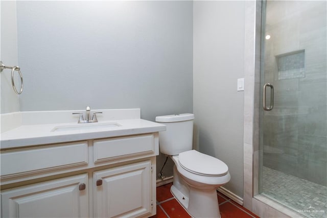 bathroom featuring toilet, vanity, tile patterned floors, and walk in shower