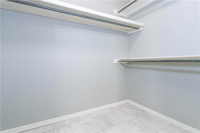 walk in closet with tile patterned floors