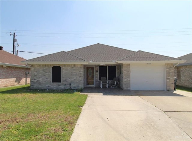 ranch-style home featuring roof with shingles, concrete driveway, an attached garage, a front yard, and brick siding