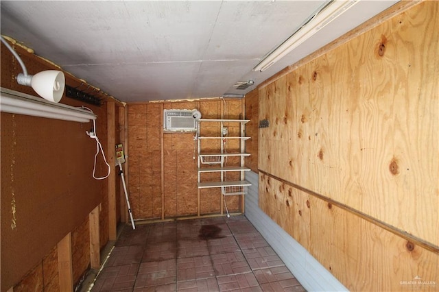 storage room featuring a wall mounted air conditioner