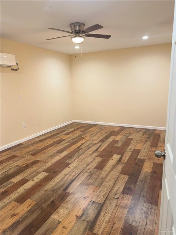 3013 Ozark Ave, Mcallen, TX 78504 - spare room featuring a ceiling fan, hardwood / wood-style floors, baseboards, a wall unit AC, and recessed lighting