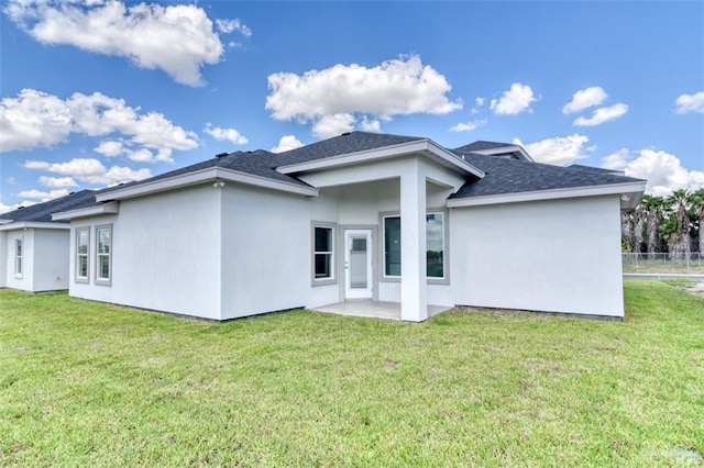 rear view of property featuring a yard