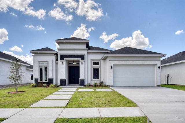 prairie-style home with a front lawn and a garage