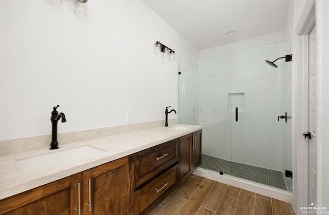 2080 Eagle Landing Dr, Edinburg, TX 78542 - full bathroom featuring a shower stall, double vanity, and wood finished floors