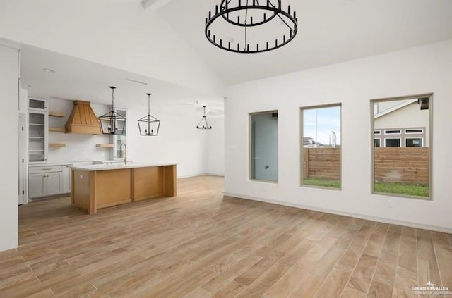 2080 Eagle Landing Dr, Edinburg, TX 78542 - kitchen with open shelves, open floor plan, light wood-type flooring, premium range hood, and beamed ceiling