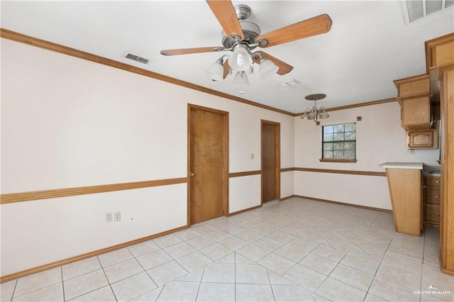 spare room with ceiling fan with notable chandelier, crown molding, and light tile patterned flooring