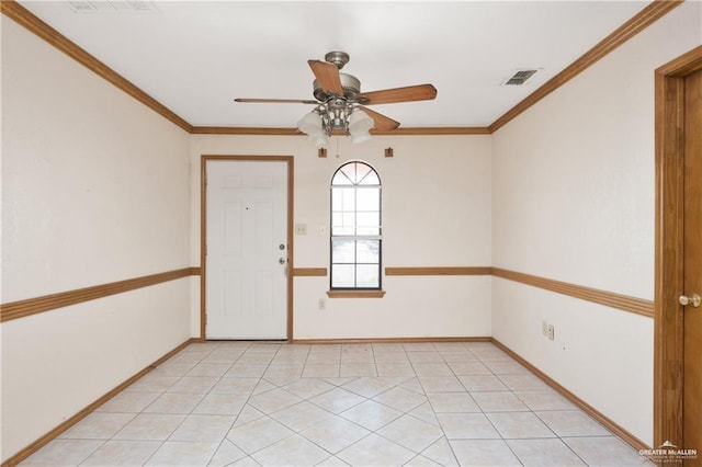 empty room with ceiling fan, light tile patterned flooring, and ornamental molding