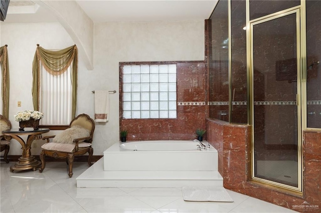 bathroom with a garden tub, tile patterned flooring, and a stall shower