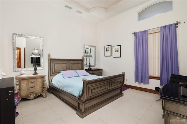 bedroom featuring baseboards, visible vents, and light tile patterned floors