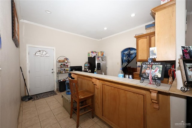 kitchen featuring tile countertops, stainless steel fridge with ice dispenser, ornamental molding, and light tile patterned floors