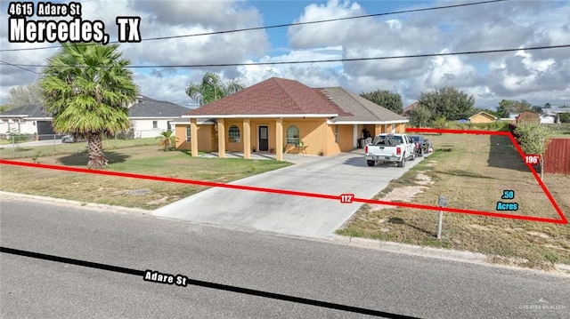 view of front of house with a front yard and a carport