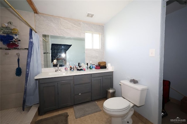 bathroom with tile patterned floors, vanity, toilet, and a shower with curtain