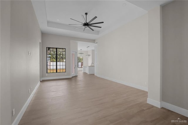 empty room featuring ceiling fan and light hardwood / wood-style floors