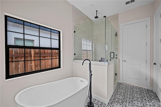 bathroom featuring tile patterned flooring and independent shower and bath