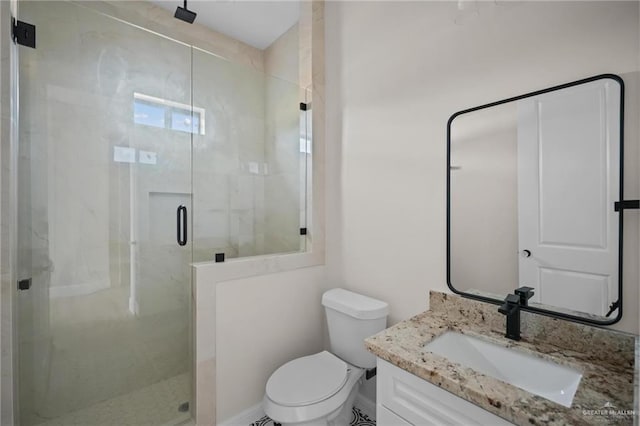 bathroom with vanity, toilet, and a shower with shower door