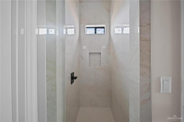 bathroom with a tile shower